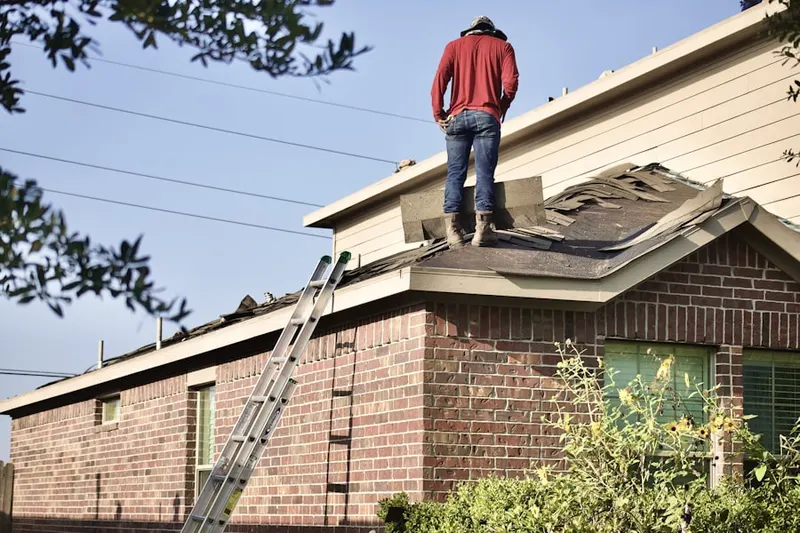 Professional roofer working on a residential roof in Peachtree North